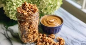 Peanut butter protein granola served in bowl with Peanut butter for high protein breakfast