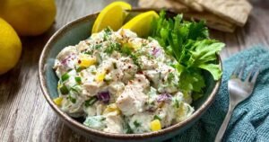 High protein cottage cheese chicken salad with banana peppers served in white bowl showing creamy texture