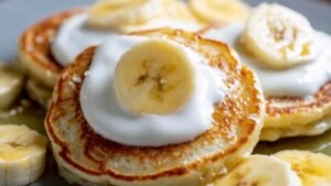 Easy protein pancakes with Greek yogurt stacked on plate showing fluffy texture