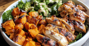 Grilled chicken sweet potato bowl with quinoa, avocado, and tahini dressing showing vibrant colors