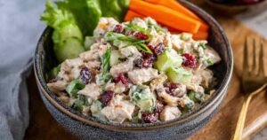 Healthy chicken salad without mayo using greek yogurt recipe in white serving bowl with fresh herbs