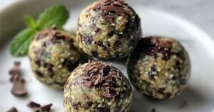 Mint chocolate chip protein balls arranged on parchment paper showing texture and chocolate chips
