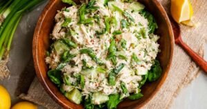 Easy rotisserie chicken salad with apples and greek yogurt in large mixing bowl showing creamy texture