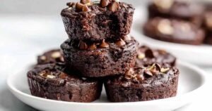 Protein brownie bites cooling in silicone baking cups showing fudgy chocolate texture