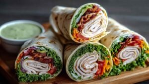 California Turkey Club Wraps cut in half showing turkey bacon avocado filling high protein meal
