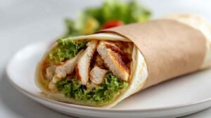 Healthy air fryer chicken wraps seasoned chicken cubes cooking in air fryer basket