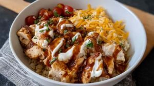 Macro friendly BBQ ranch chicken bowl with grilled chicken, cottage cheese, and melted cheddar cheese