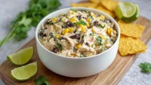 Southwest chicken salad with black beans corn and avocado in white serving bowl