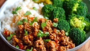 Sweet and Spicy Ground Turkey Broccoli Bowls served over brown rice with sesame seeds