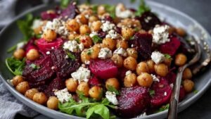 Colorful Chickpea Beet and Feta Salad in white bowl showing vibrant red beets and chickpeas