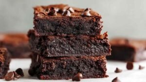 Cottage cheese brownies cut into squares on white plate
