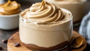 Cottage cheese peanut butter mousse in clear glasses topped with berries