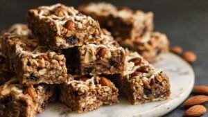 High-protein granola bars pressed in parchment-lined baking pan ready to be cut