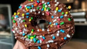 Low calorie chocolate protein donuts with chocolate frosting on cooling rack